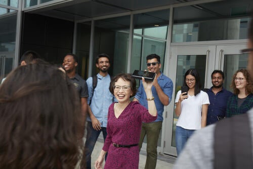 Engineering students share a laugh with their dean, pictured at centre.