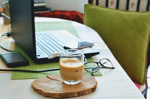 Image of home desk area with a coffee cup in front