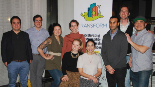 TRANFORM team posed in front of sign.