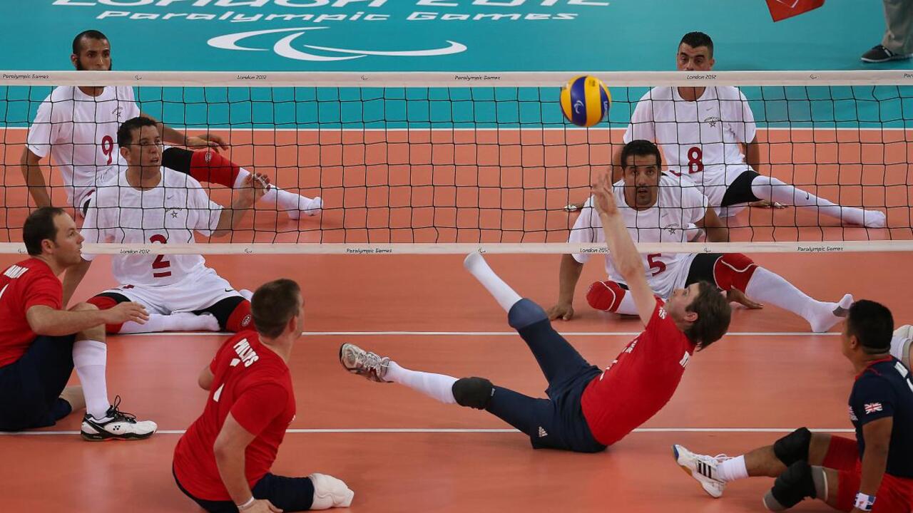 Sitting volleyball players on court