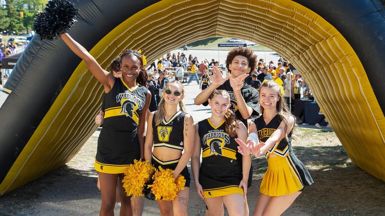 Cheerleaders pose near the field 