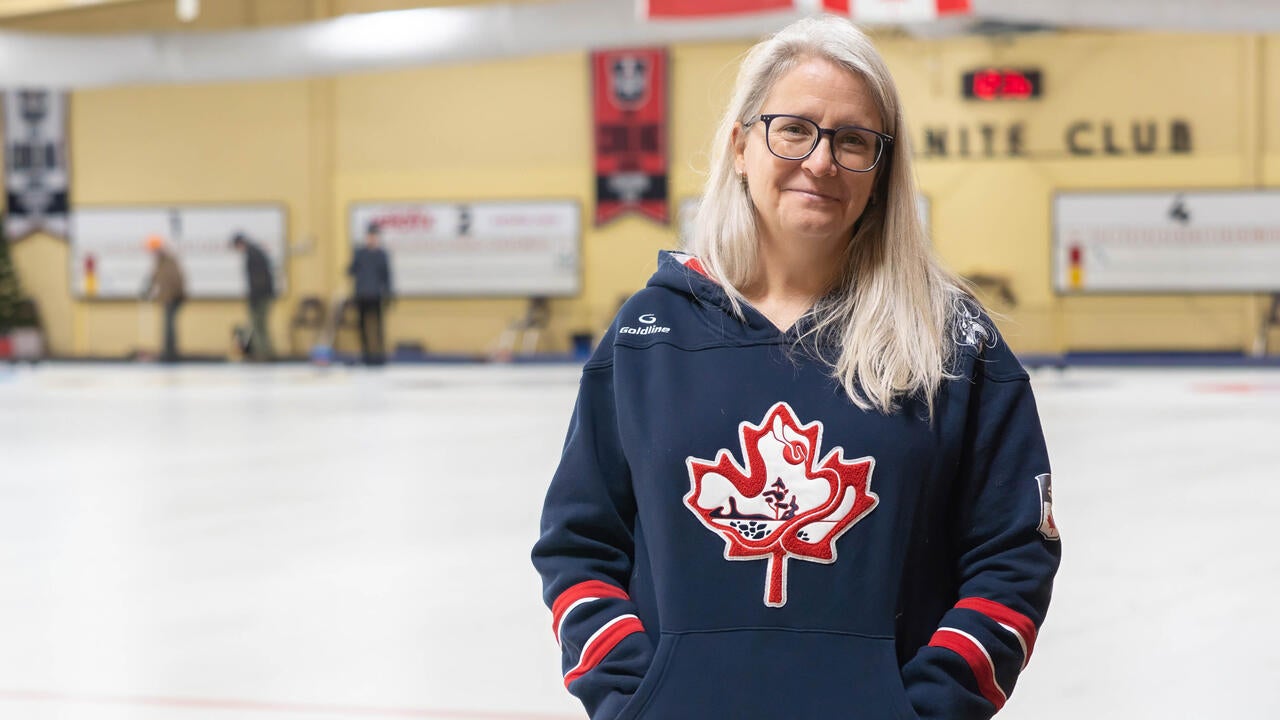 Heather Mair stands beside curling sheets at Waterloo's Granite Curling Club