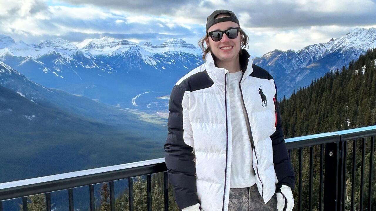 Brett Hummel smiling with mountains in the background