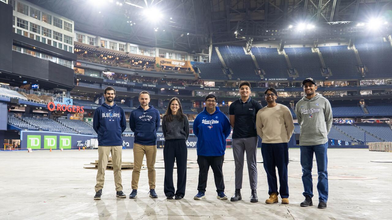 Group poses together on field level at Rogers Centre