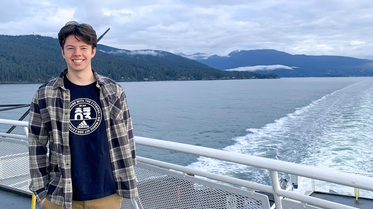 Thomas Coleman poses on the bow of a ferry between the Lower Mainland and Vancouver Island