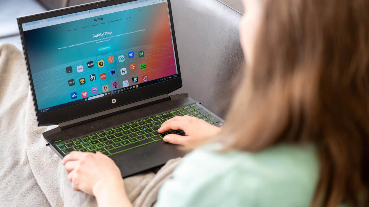 A lady sitting looking at a laptop screen