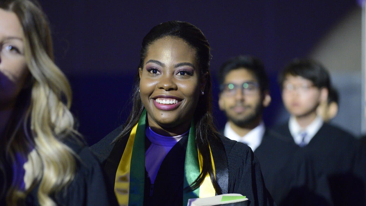 Students walk together at graduation.