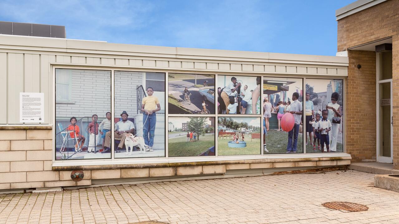 large print photos in the windows of campus building