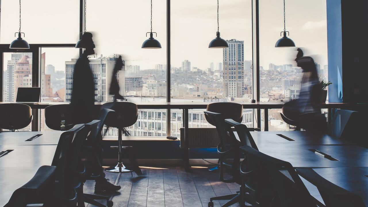 People walk across an office
