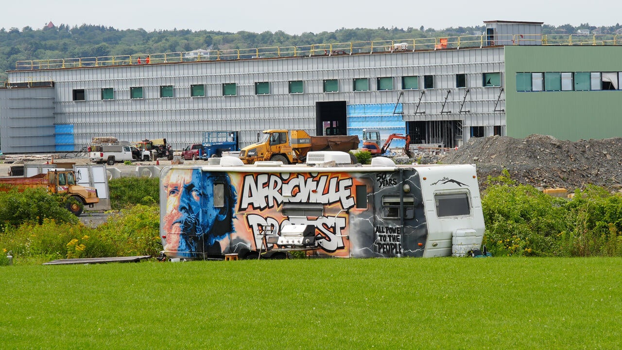 Old bus with graffiti paintings resting on a green lawn