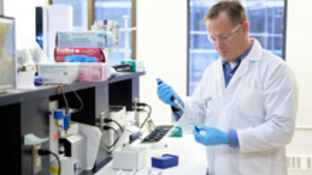 Professor Ken Stark taking a sample of blood in Waterloo laboratory