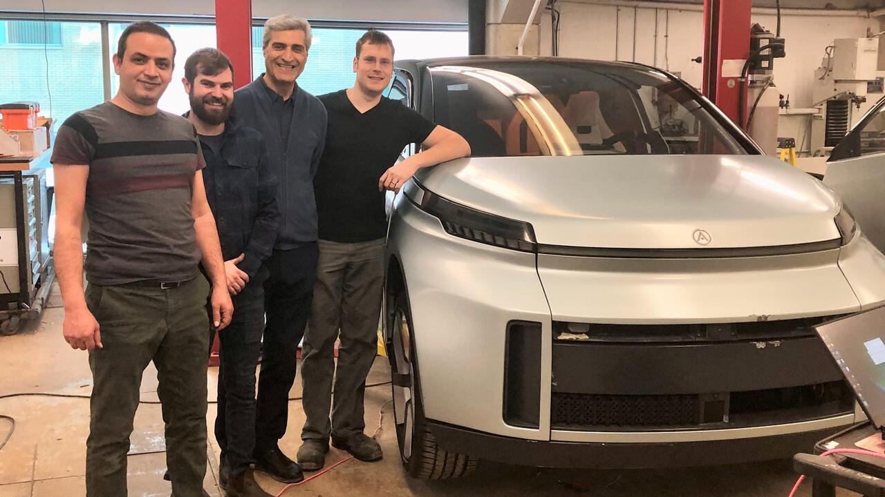 Amir Soltani (left to right), Mike Duthie, Amir Khajepour and Jeff Graansma in their Waterloo Engineering lab with the Arrow.