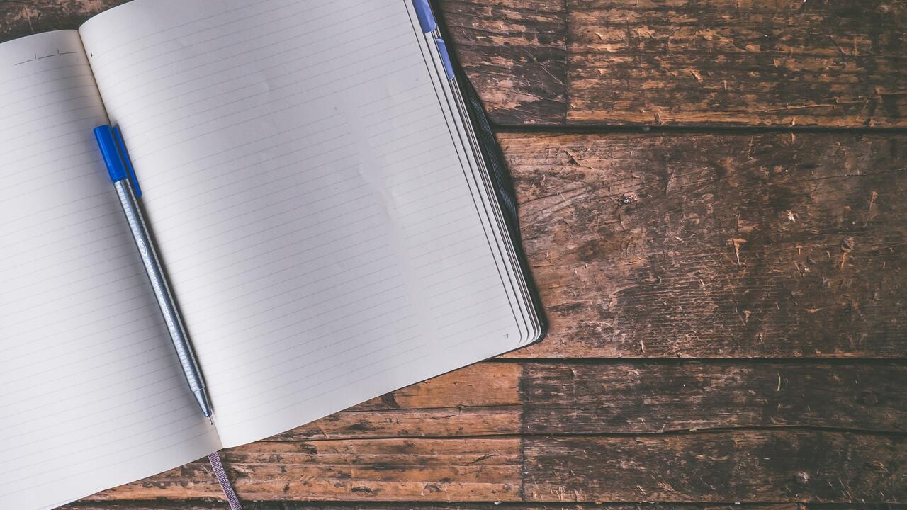 an open notebook and pen
