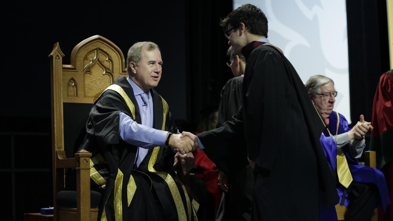 Jenkins congratulating a student