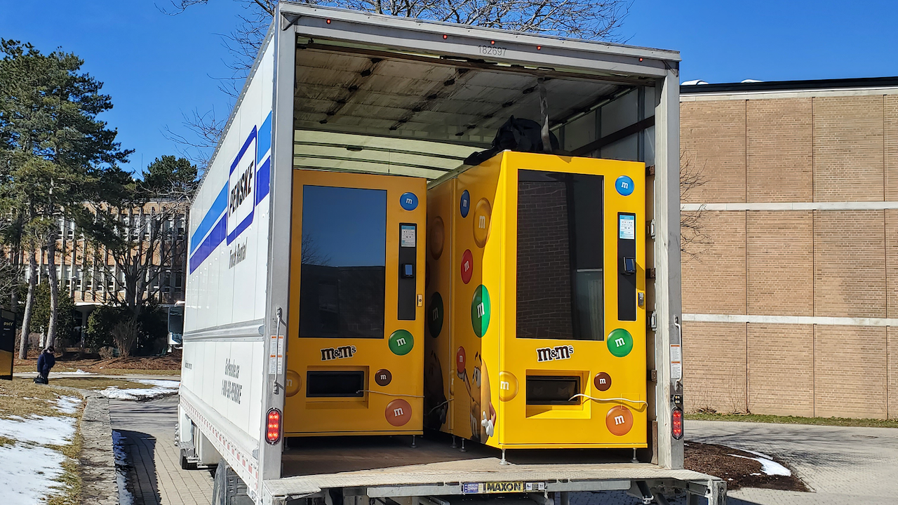 Vending machines containing m&m candies and pin-hole cameras are loaded in the back of a moving truck removed from UWaterloo