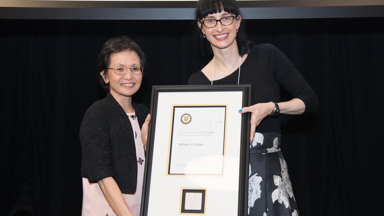 Dean Pearl Sullivan and Barb Paldus holding framed award