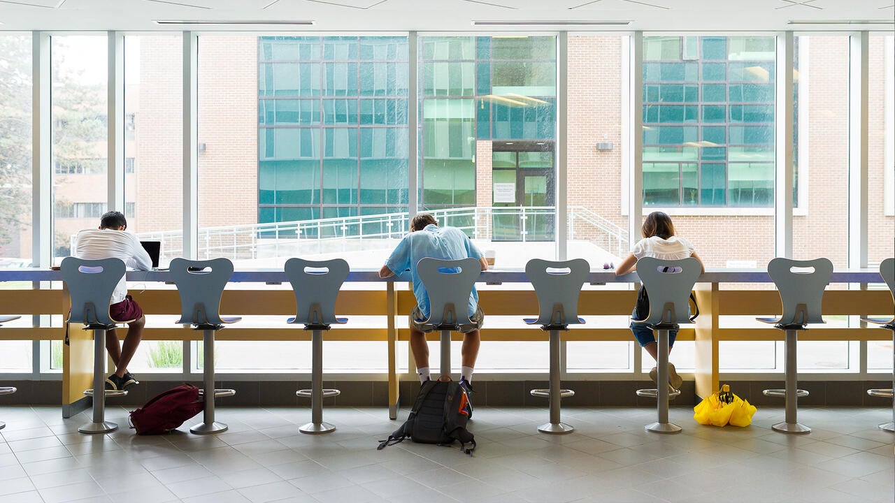 Students sitting at window