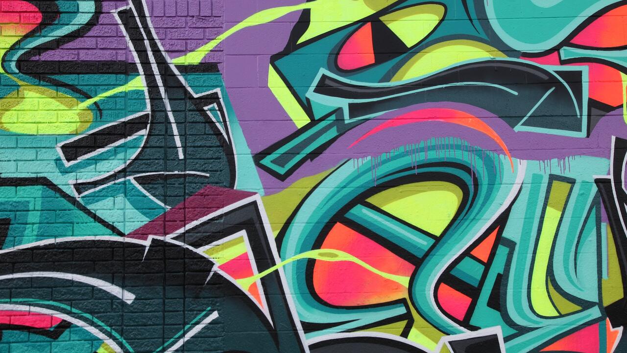 A wall with colourful graffiti