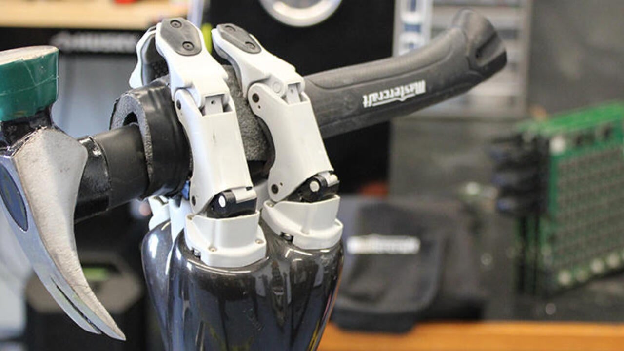 Robot hand holding a hammer