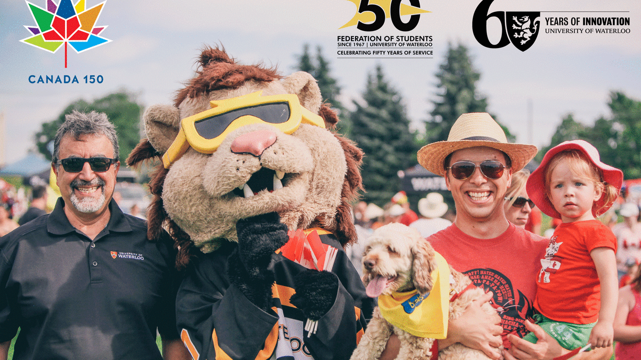 President Feridun Hamdullahpur with King Warrior and a man holding a child and a dog at Canada Day festivities