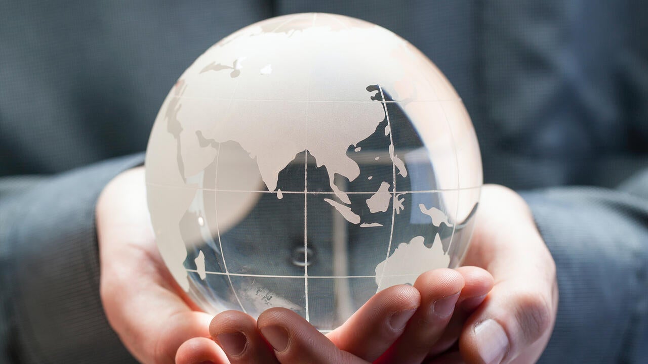 Transparent globe held by hands