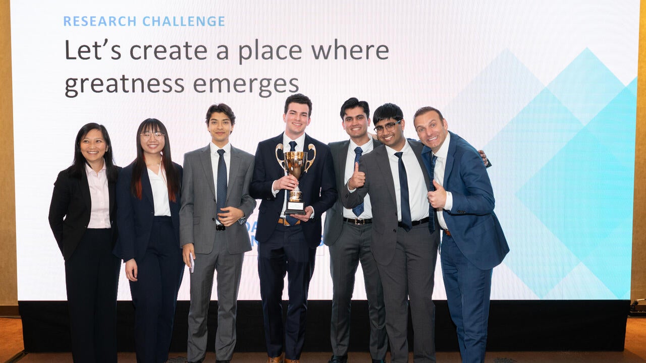 Waterloo students at the CFA Institute's Research Challenge in Poland holding their award
