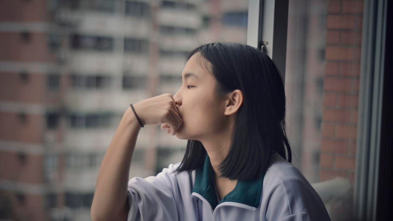 Child looking outside the window