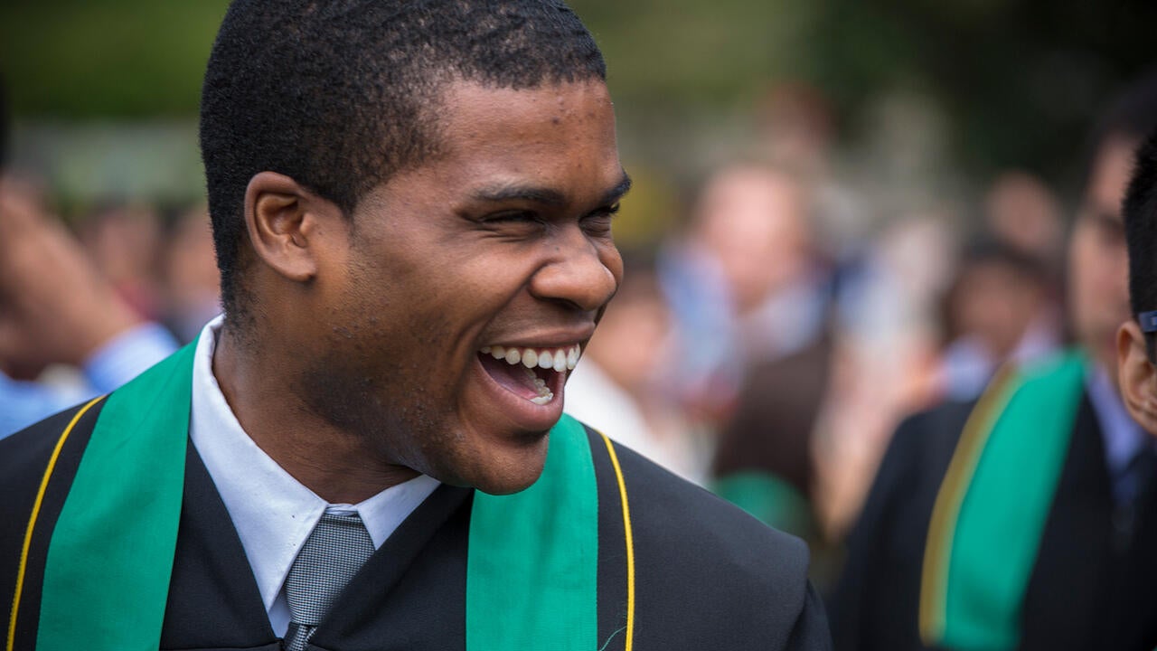 male student smiling at convocation