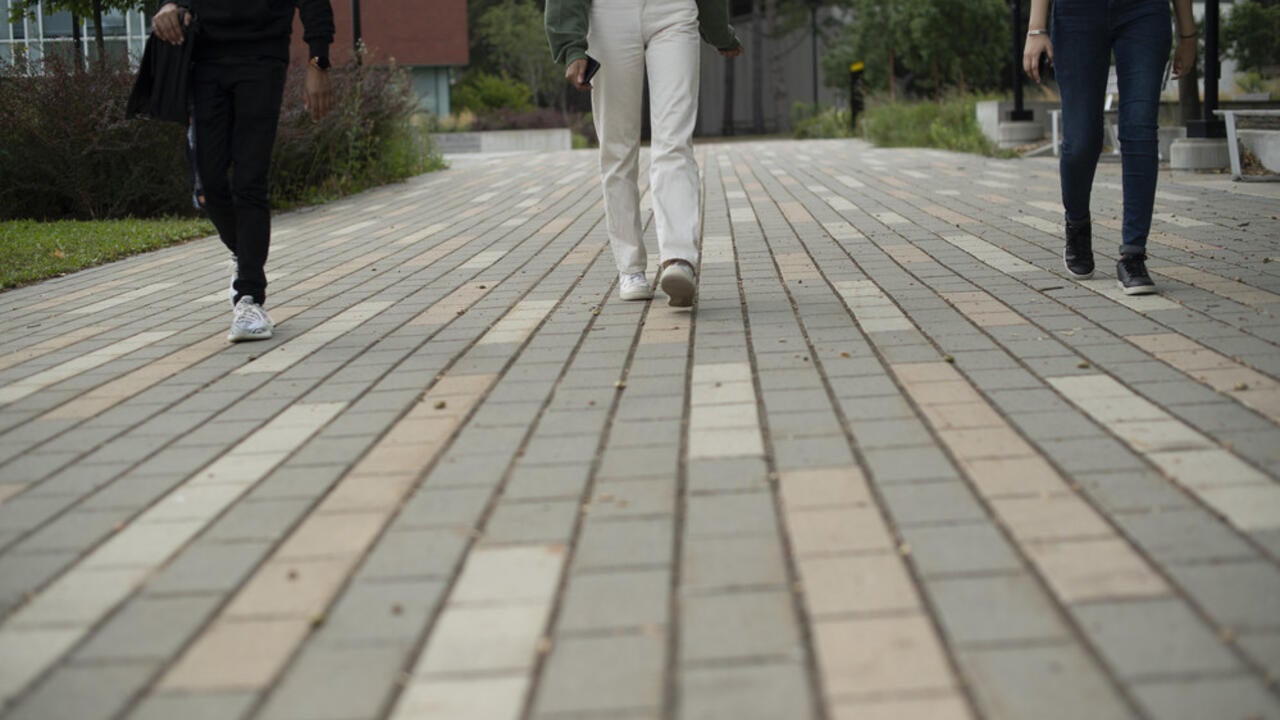 Students walking along campus path