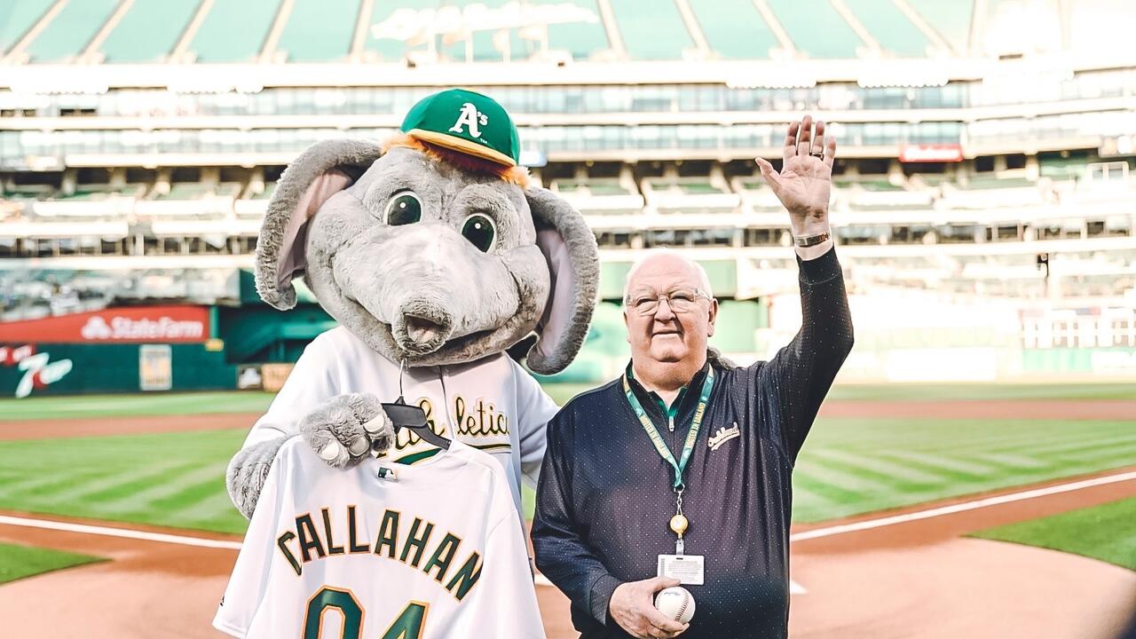 Dick Callahan poses for a photo with the Oakland A's mascot