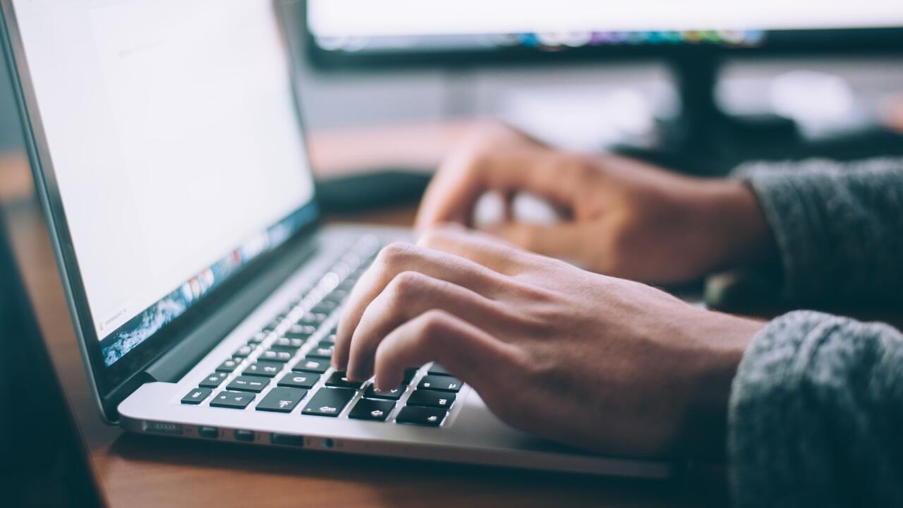 person typing on computer