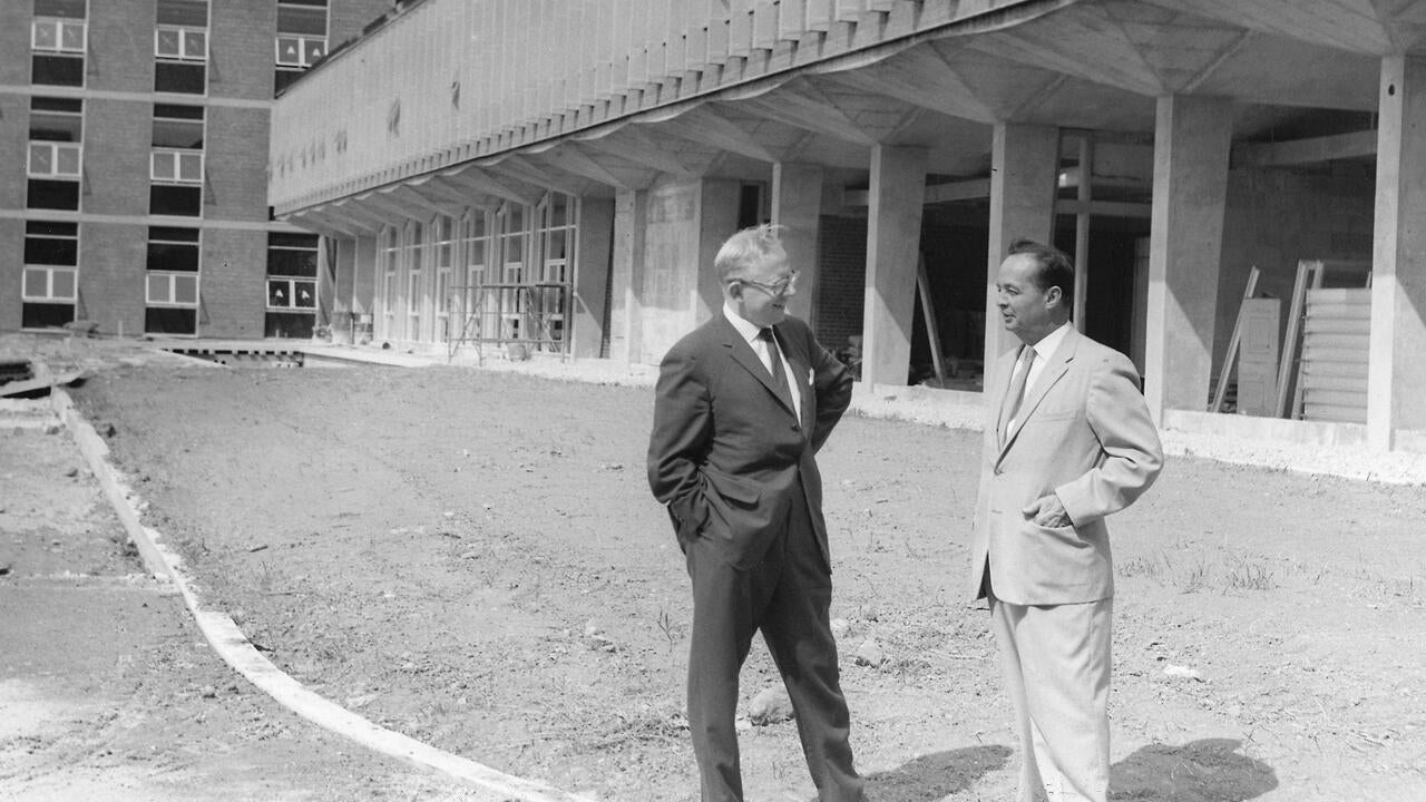Doug Wright standing with colleague outside of Engineering 2 building