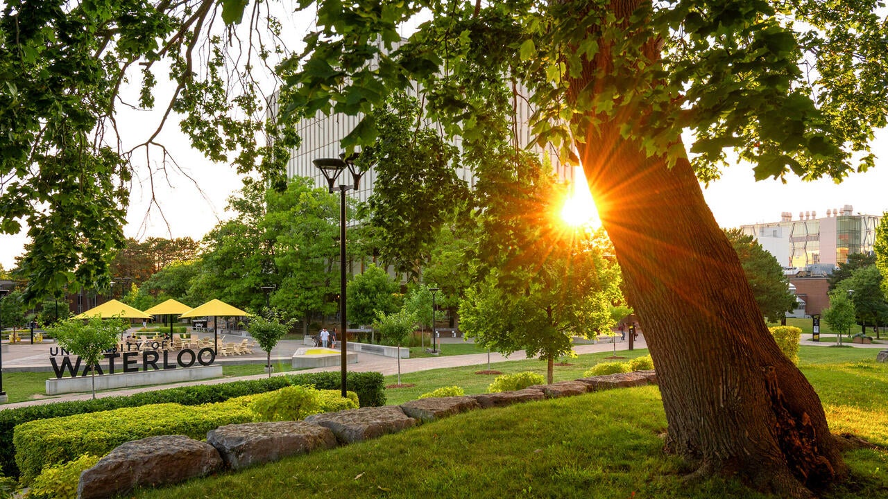Sunset beside Dana Porter Library with Waterloo sign in the foreground