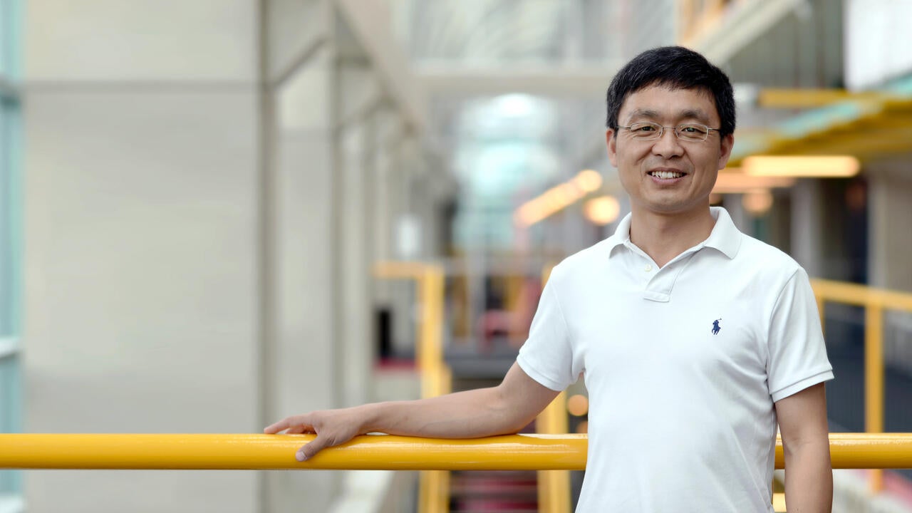 Professor Bin Ma standing inside Davis Centre