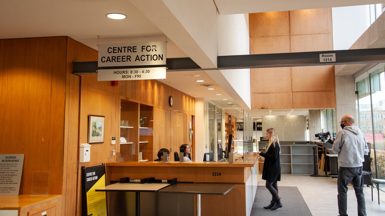 Madison standing at the welcome desk for the Centre for Career Action