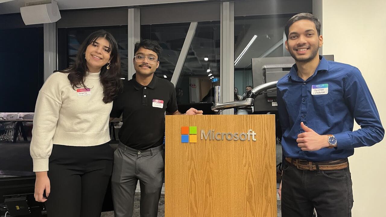 Undergraduate students standing at Microsoft podium in Toronto