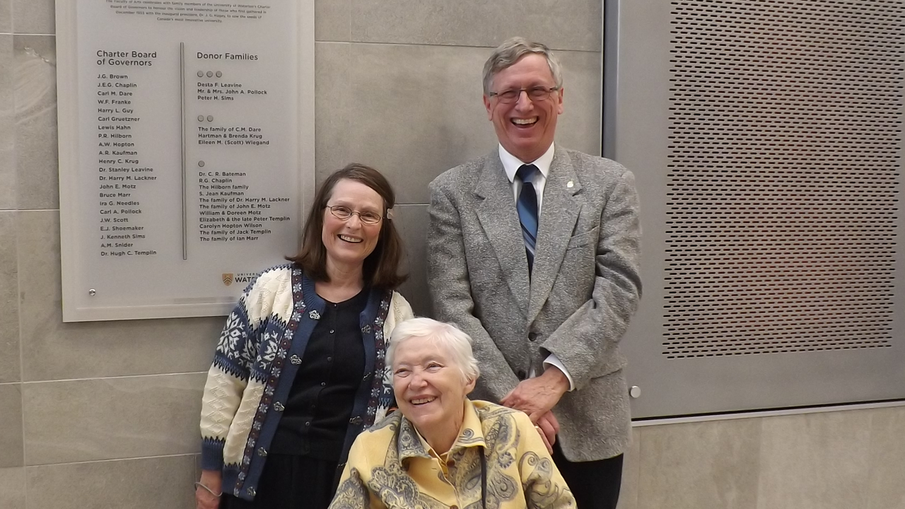 Murray and Nancy stand behind Eileen, who is sitting in a wheelchair