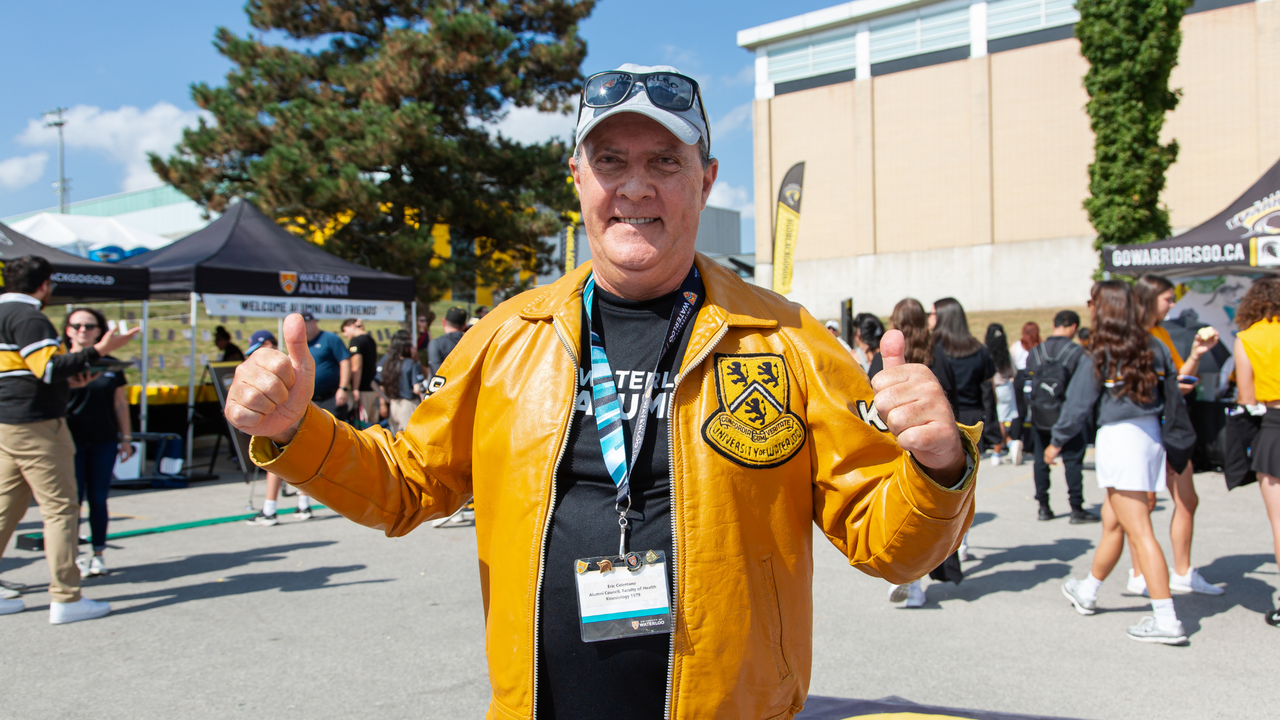Eric poses at Homecoming with his leather Waterloo jacket