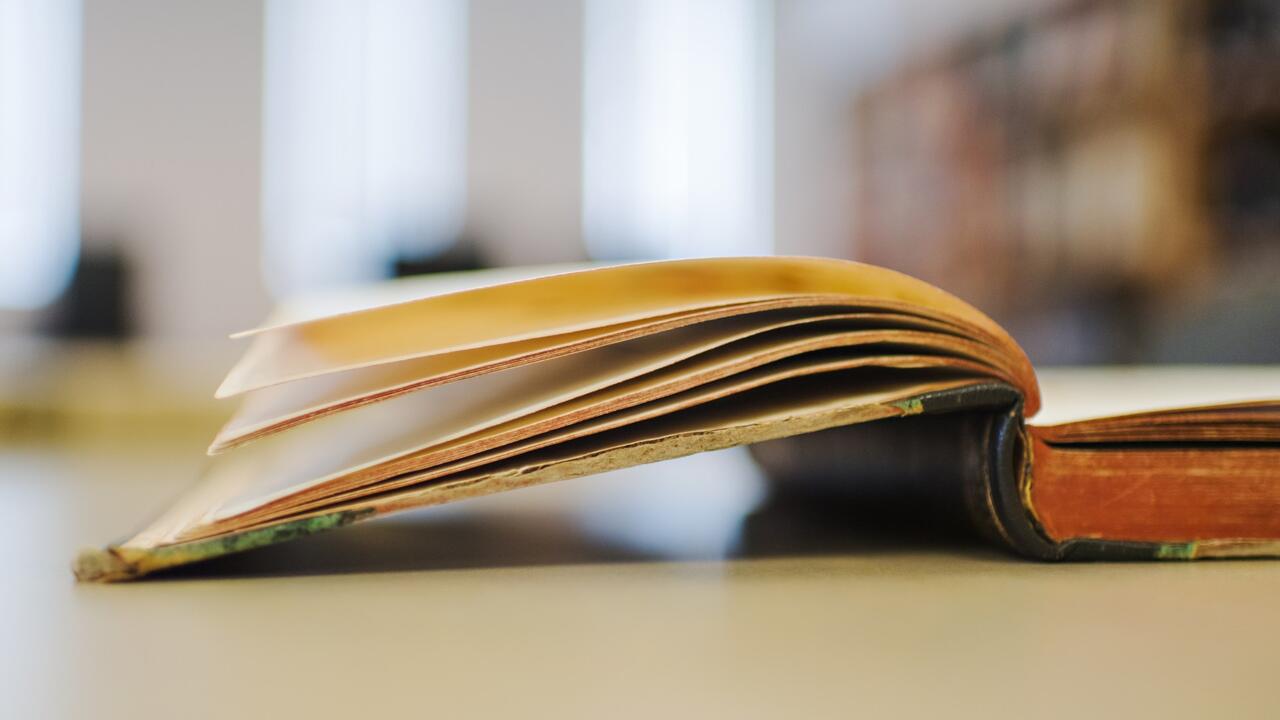 Book from the archives lies open on a table