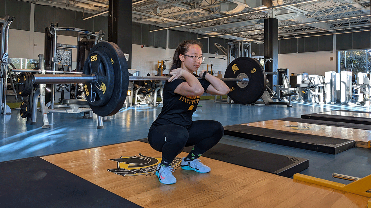 Evelyn Jiang lifts heavy weights in gym