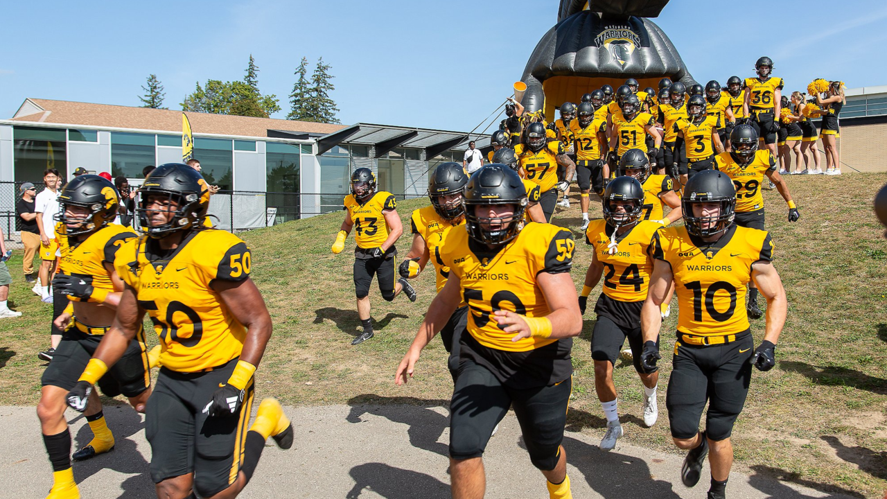 The Waterloo Warriors football team walking out to a game