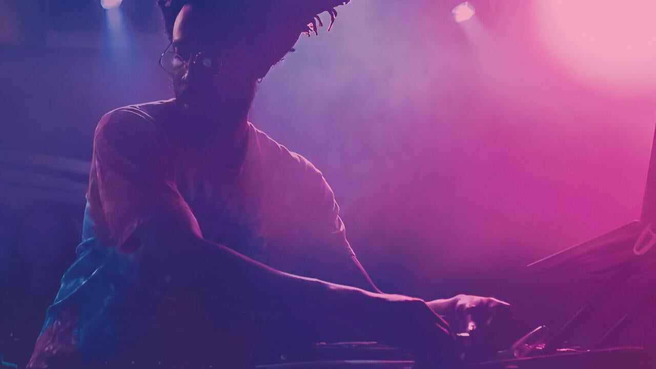 Chris Wilson djing with a purple-pink filter on the image