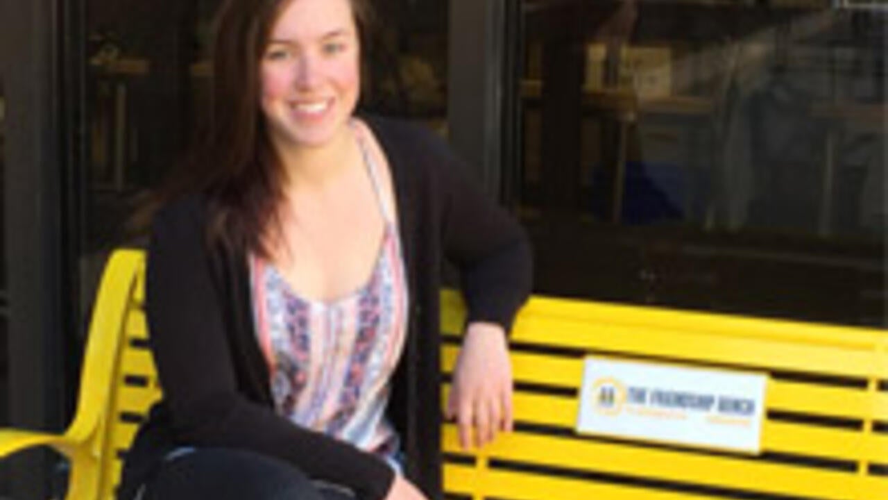 Hannah sitting on the designated friendship bench