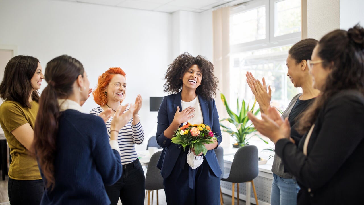 Businesswomen celebrating an achievement of a colleague
