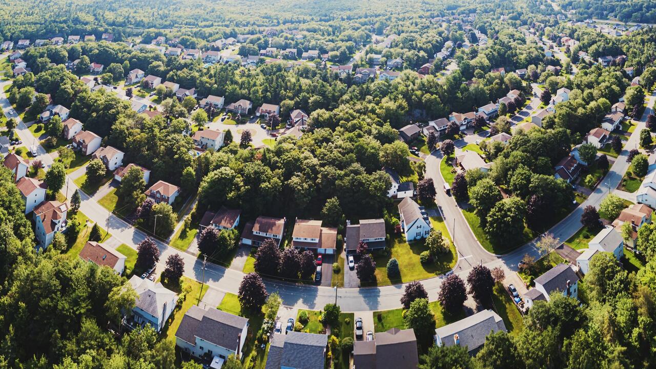 Aerial view of large subdivision with houses and trees