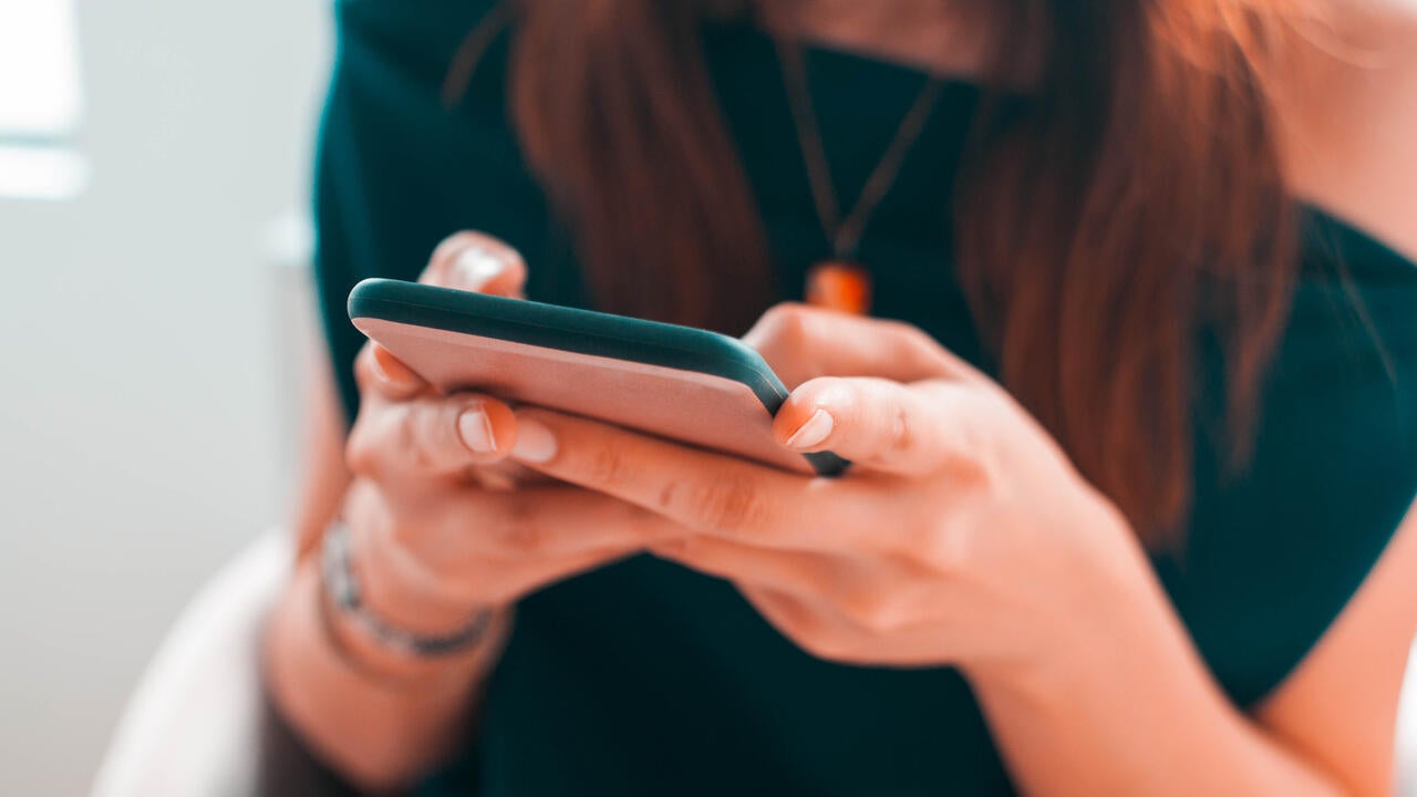 A close-up view of a young woman using her smartphone