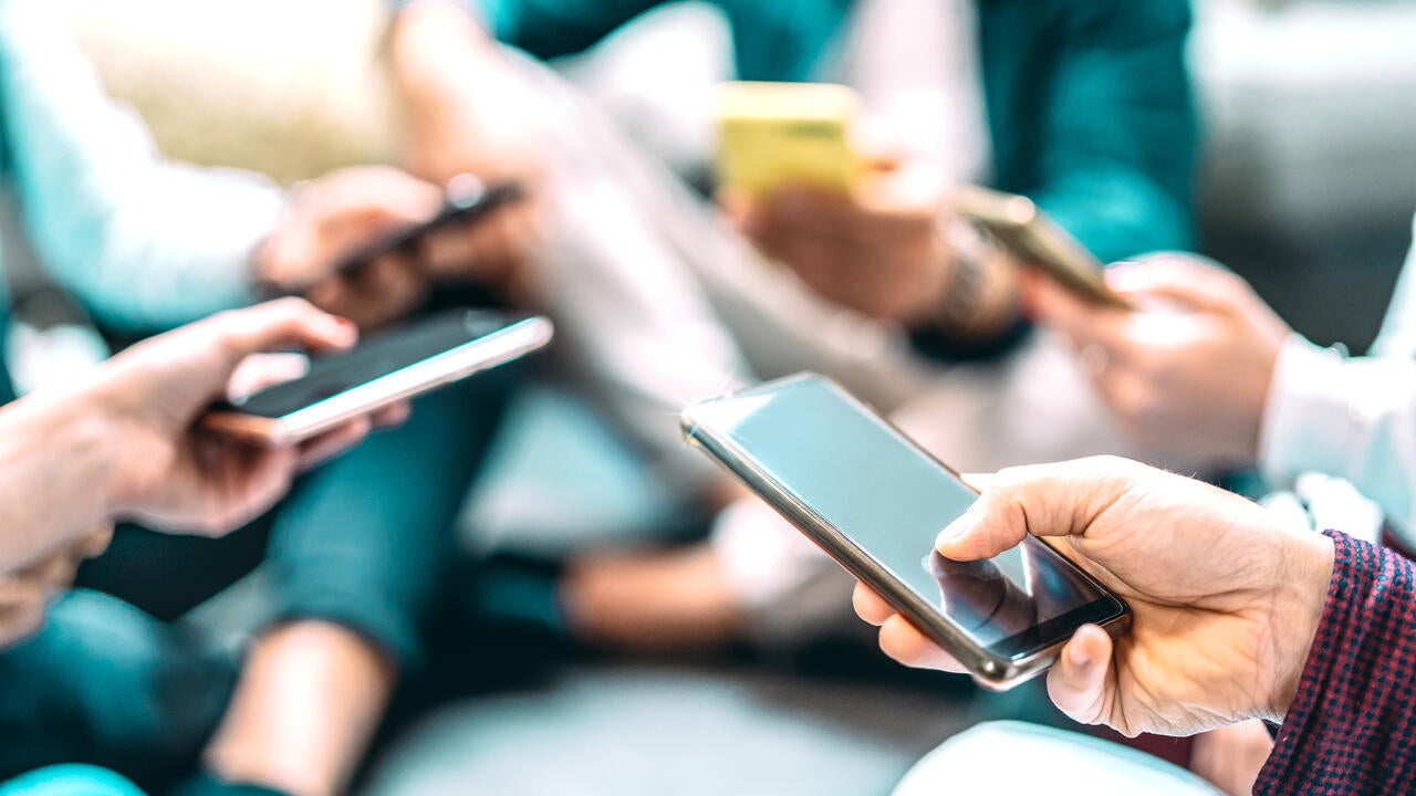 Close up of people using mobile smart phones