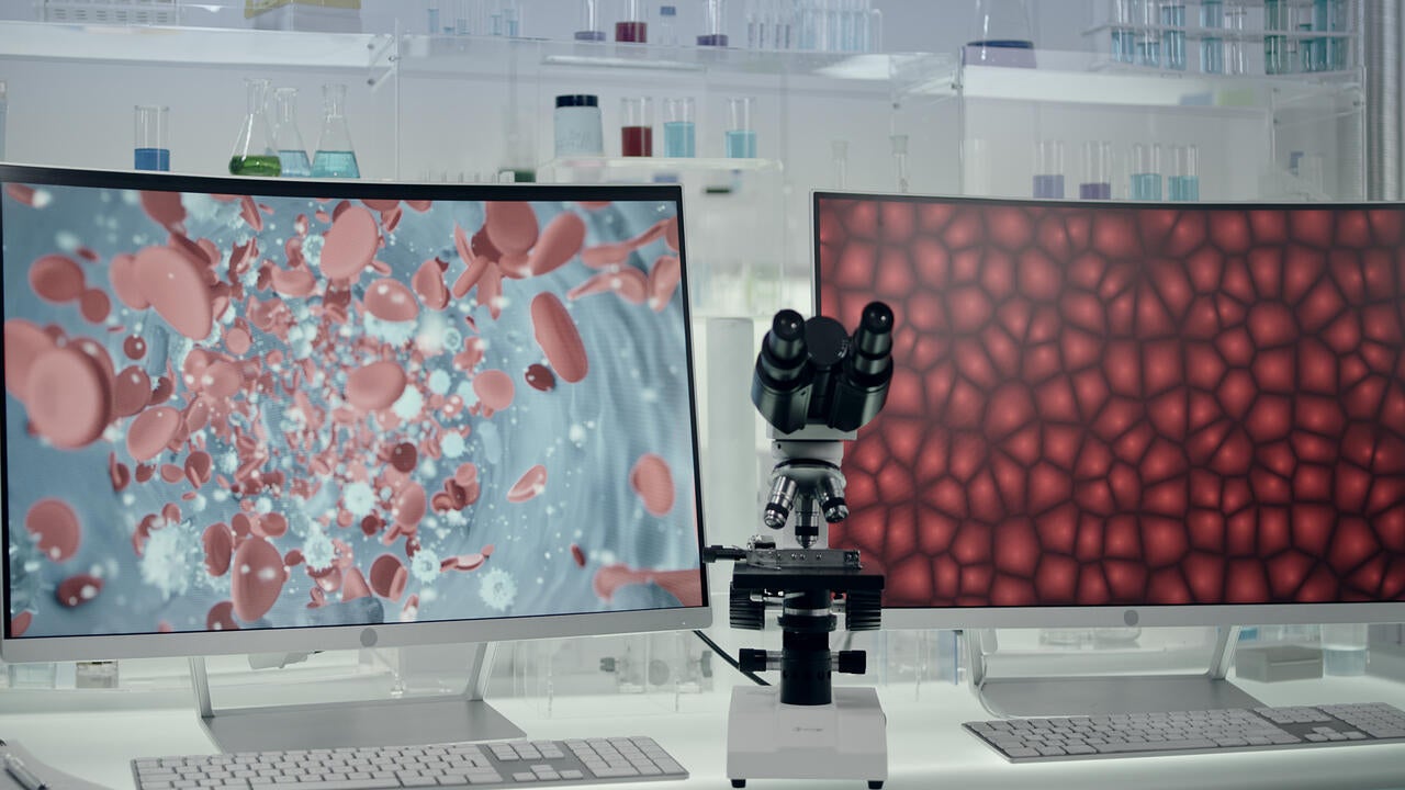 Futuristic laboratory equipment with blood cells research on computer screens