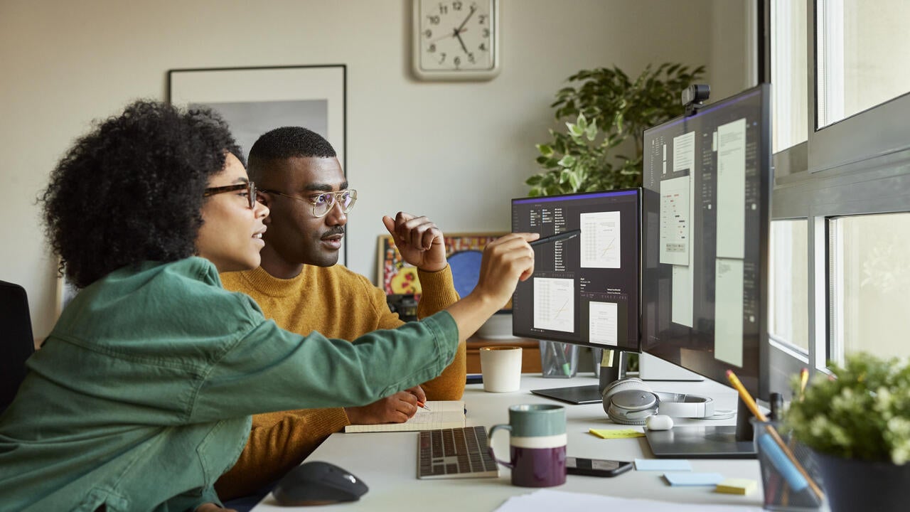 Male and female entrepreneurs are working at desk. 