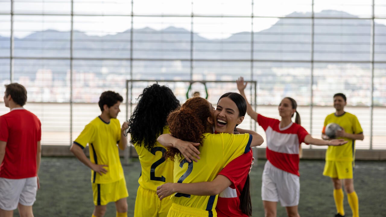 Players celebrating while playing a soccer game 